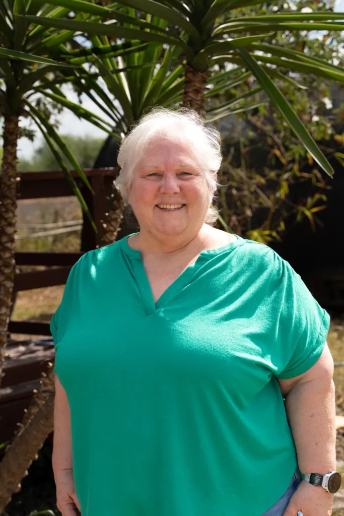 Hope for SFS team member standing outdoors in a bright green shirt