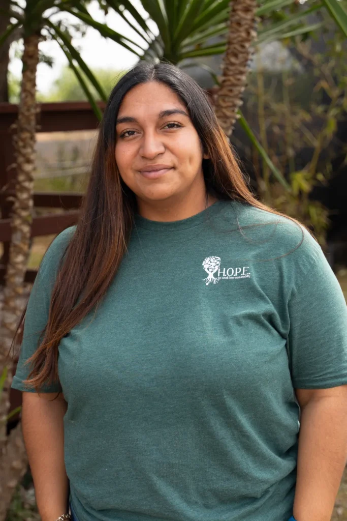 Maria Chavez wearing a green Hope for SFS logo shirt outdoors
